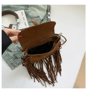 Detail view of the open bohemian tassel bag with brown suede finish and inner zipper pocket
