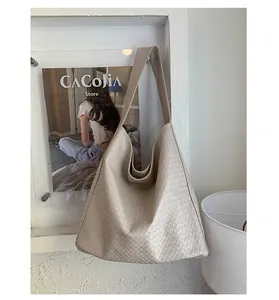 Detail of the high-quality woven texture on this large beige shoulder tote bag