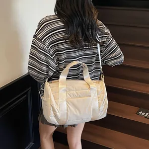 Quilted beige nylon boston bag for travel featuring large capacity and crossbody strap