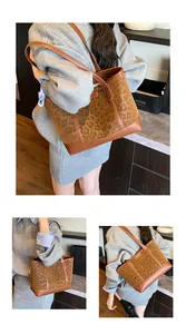 Detail of the leopard print tote bag with brown leather straps and gold metal logo