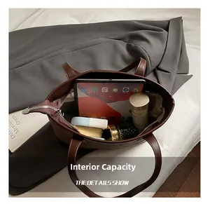 Internal capacity of large leather tote bag showing space for tablet and cosmetics