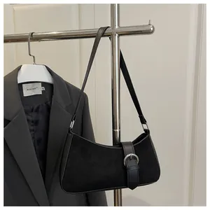 Detail of black crescent shoulder bag with mixed suede leather and silver metal buckle