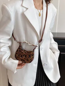 Mini leopard print crossbody bag with brown leather bows and lace wrapped handle detail