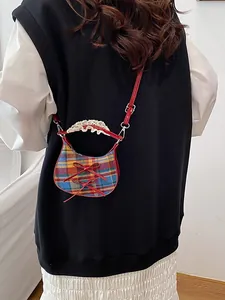 Mini plaid crossbody bag with red bows and lace handle shown on model back view