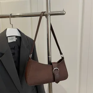 Deep brown retro underarm bag in suede and smooth leather for minimalist office style