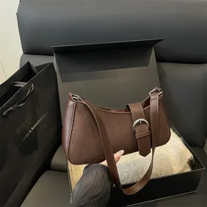 Minimalist coffee brown baguette shoulder bag with matte suede texture and adjustable strap