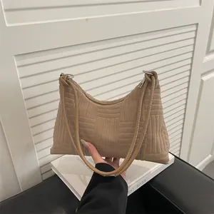 Large khaki tote bag with geometric textured surface and long shoulder straps