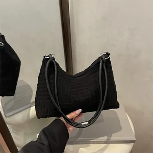 Minimalist black geometric tote bag with textured fabric and metallic silver rings