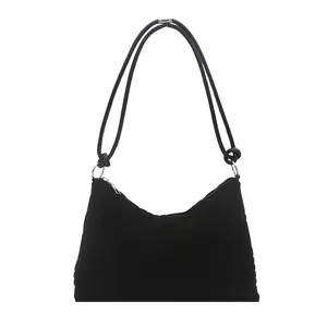 Large black tote bag with vertical texture and metal rings for daily commuting