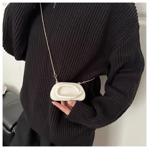 Detail of cream white marble texture acrylic crossbody bag with gold chain strap