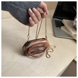 Detailed amber marble texture acrylic mini bag with golden chain and round handle