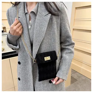 Detail of classic black quilted velvet mini crossbody bag with golden chain and clasp lock