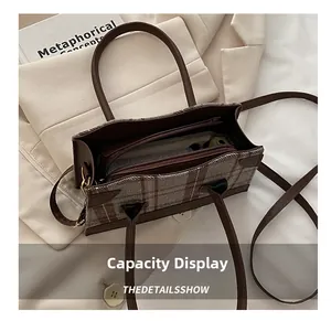 Capacity display of retro plaid bucket bag showing interior space for phone and wallet