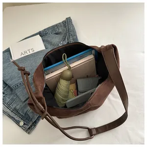Internal view of large brown suede shoulder bag showing high storage capacity