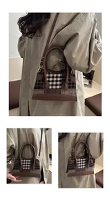 Detail shot of vintage plaid bucket bag with brown leather handles and adjustable strap