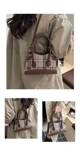 Detail of vintage checkered bucket bag with leather handles and gold-tone hardware
