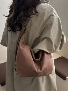 Large vintage brown suede hobo shoulder bag for women on model in autumn style