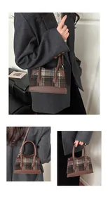 Close-up of vintage brown plaid handbag with leather accents on grey woolen coat