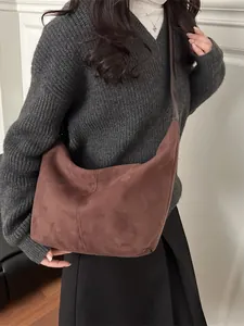 Retro large brown suede underarm bag for women showing casual commuter style