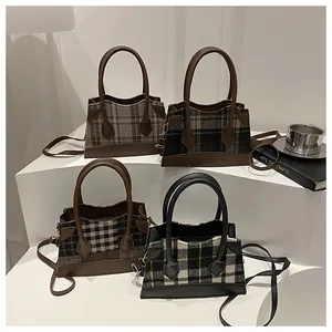 Retro plaid crossbody bucket bags in four patterns on white display stands with props