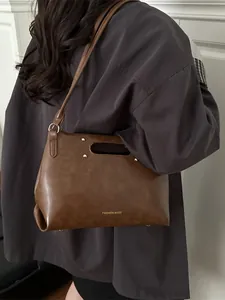 Retro dark brown PU leather handbag with hollow handle and gold fashion lettering