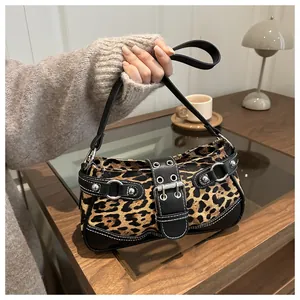 Détails du sac léopard avec clous argentés et boucle en cuir vintage sur une bandoulière