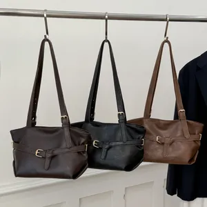 Minimalist leather tote bags in brown and black with adjustable metal buckle straps
