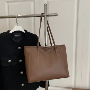 Brown leather tote bag for women featuring long shoulder straps for office and casual commute