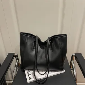Minimalist black tote bag in matte faux leather for women's casual or office commute