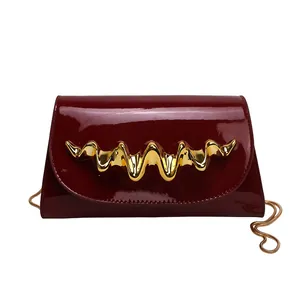 Fashionable wine red glossy evening clutch with gold wave metal hardware and chain strap