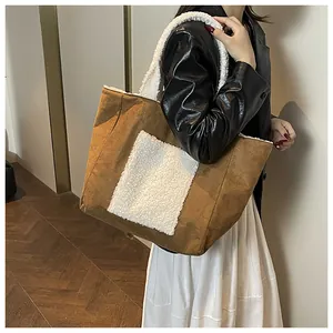 Detail of plush tote bag showing faux suede texture and cozy white fleece handle