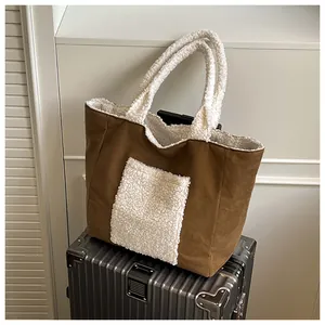 Detail of brown suede and white faux fur patchwork on a large tote bag with warm texture