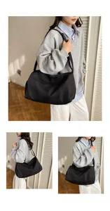Close-up of a large black waterproof yoga gym bag with an adjustable shoulder strap