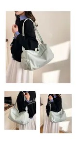 Detail of mint green nylon fitness bag showing side zipper pockets and shoulder strap