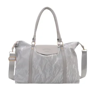 Silver-gray large travel handbag with pleated texture and adjustable strap in main view
