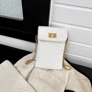 White faux shearling crossbody phone bag with gold chain strap and metal turn-lock