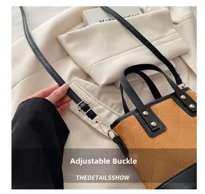 Detail of adjustable gold buckle and brown suede quilted leather on the shoulder bag