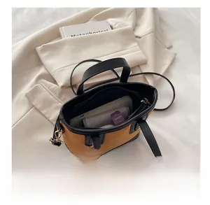 Internal view of mini bucket bag showing storage capacity for phone and wallet