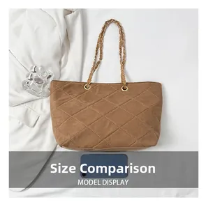 Brown suede quilted tote bag with chain strap shown with smartphone for size comparison