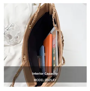 Internal capacity of khaki quilted tote bag showing space for laptop and phone