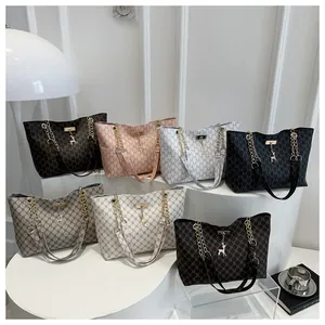 Close-up of large tote bags featuring monogram M prints and classic plaid patterns