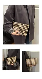 Detail of checkered woven long wallet featuring vintage patterns and zipper closure