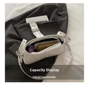 White crocodile pattern underarm bag showing spacious interior for phone and wallet