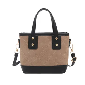Brown suede-texture bucket bag with quilted stitching and gold studs on a white background