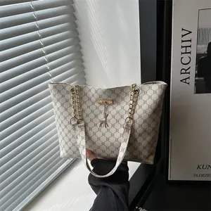 Chic beige tote bag with brown monogram pattern and deer charm for daily commute