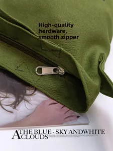 Close-up of premium silver metal zipper on vintage green canvas tote bag detail