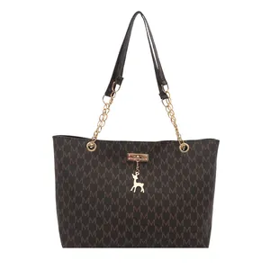Large dark brown tote bag with M letter print, chain straps, and golden deer charm
