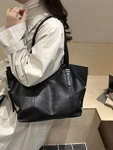 Classic black leather tote bag featuring silver star rivets and large capacity for women