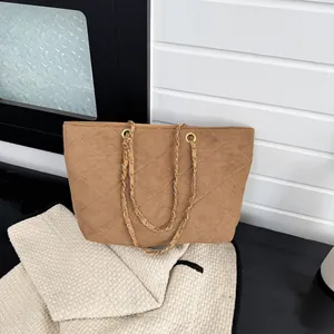 Brown suede tote bag with quilted diamond pattern and golden chain shoulder strap