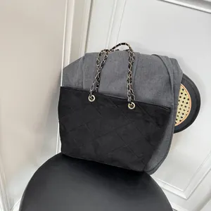 Elegant black suede tote bag with diamond quilting and gold chain strap for women